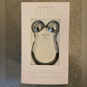 Nuface Mini Facial Toning Device with multiple charging adapters in original box